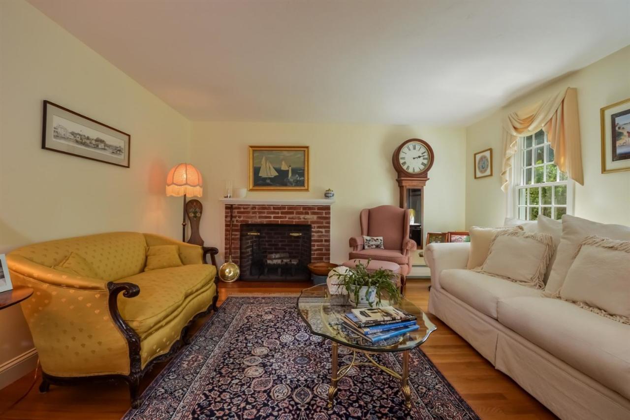 164 Scudder Road Osterville, MA 02655 - Photo 4 of 30 a living room with furniture and a fireplace