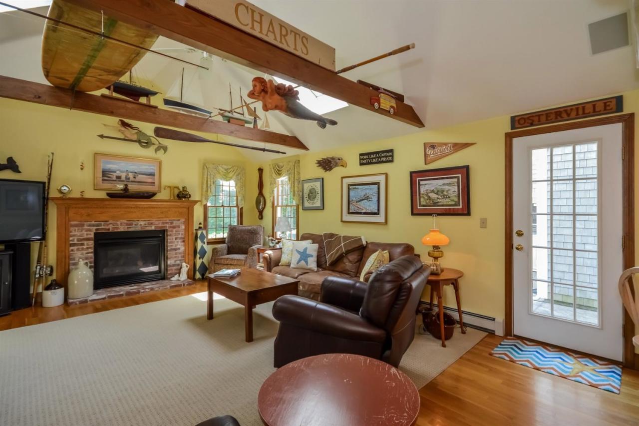 164 Scudder Road Osterville, MA 02655 - Photo 5 of 30 a living room with furniture and a fireplace