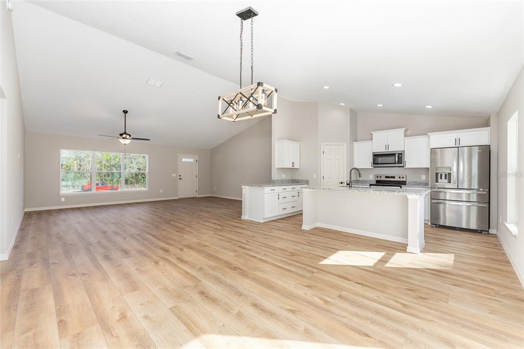 5796 Southwest 124th Ter Road Ocala, FL 34481 - Photo 14 of 63 a view of kitchen with granite countertop cabinets and refrigerator
