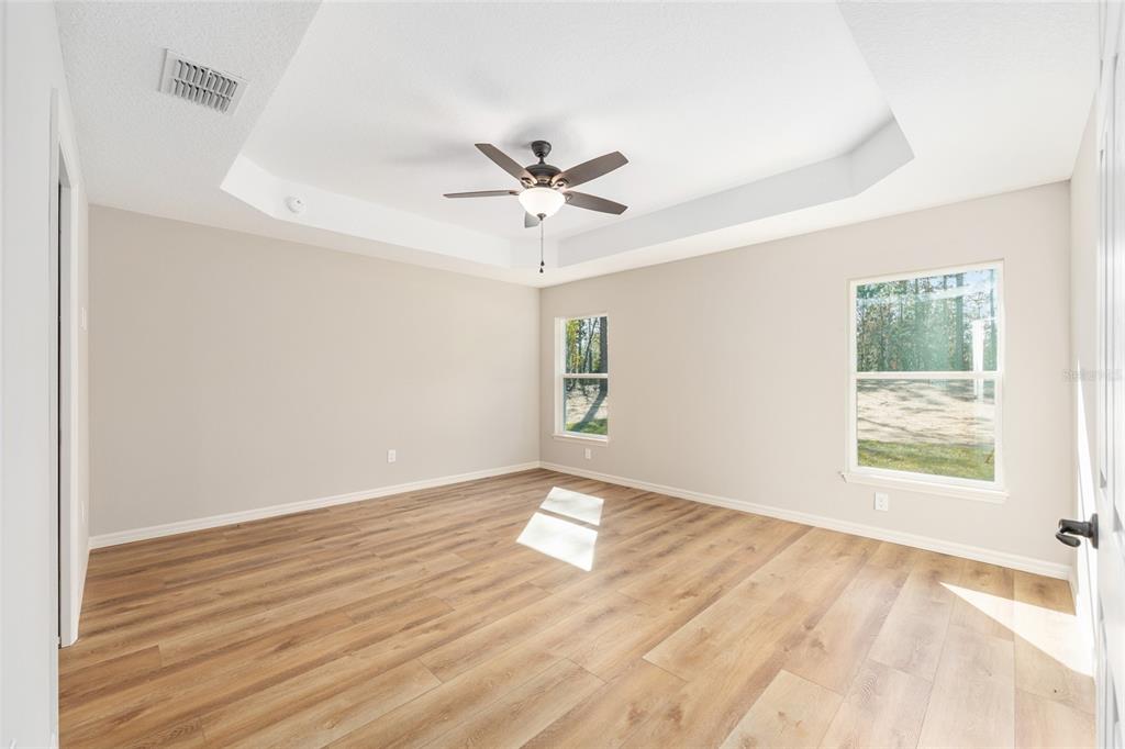 5796 Southwest 124th Ter Road Ocala, FL 34481 - Photo 22 of 63 an empty room with wooden floor and windows