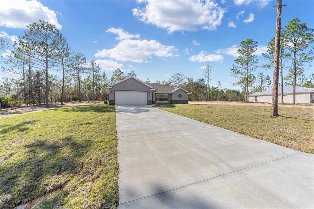 5796 Southwest 124th Ter Road Ocala, FL 34481 - Photo 40 of 63 a view of yard with swimming pool and trees