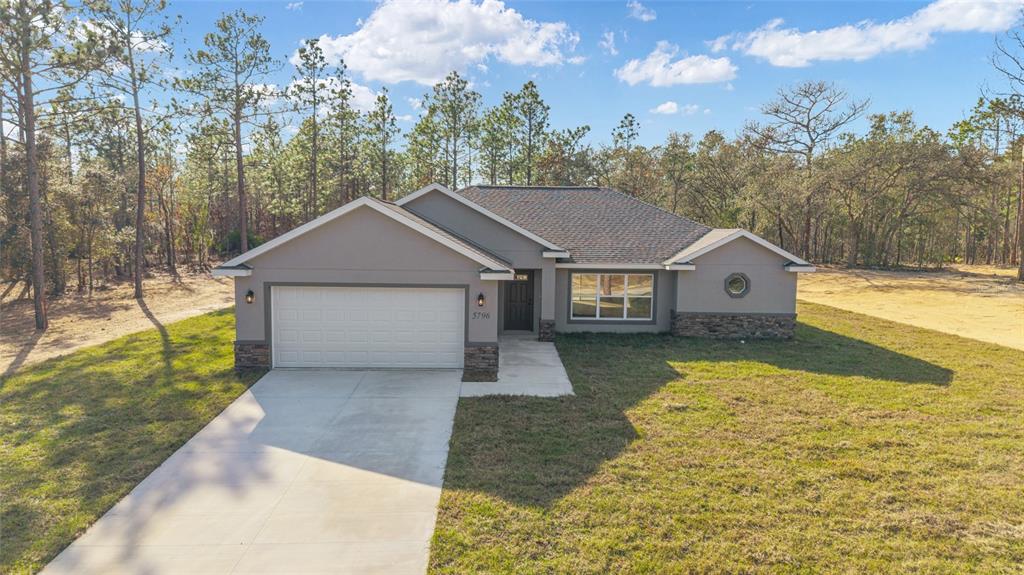 5796 Southwest 124th Ter Road Ocala, FL 34481 - Photo 47 of 63 a house with trees in the background