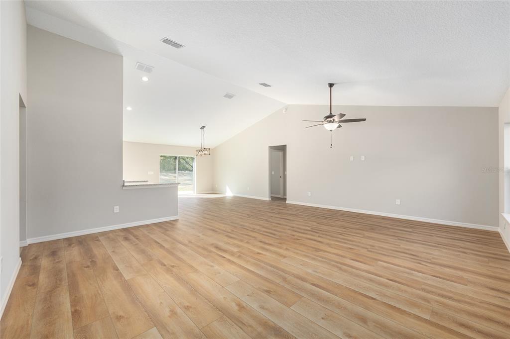 5796 Southwest 124th Ter Road Ocala, FL 34481 - Photo 6 of 63 wooden floor in an empty room with a window