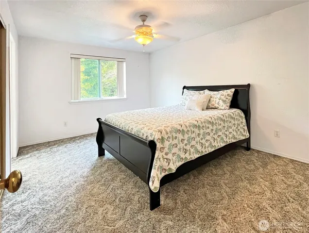 a bed sitting in a bedroom next to a window