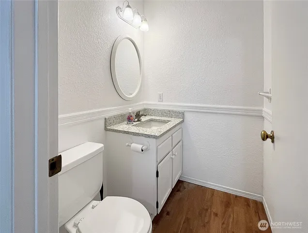 a bathroom with a sink a toilet and a mirror