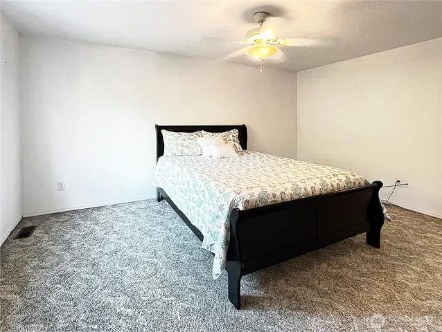 a bed sitting in a bedroom and dresser