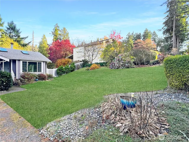 a front view of a house with a yard and a garage