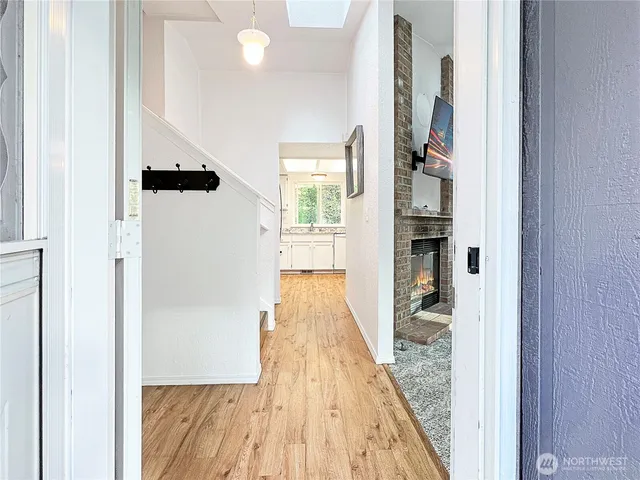 a view of a hallway with wooden floor and staircase