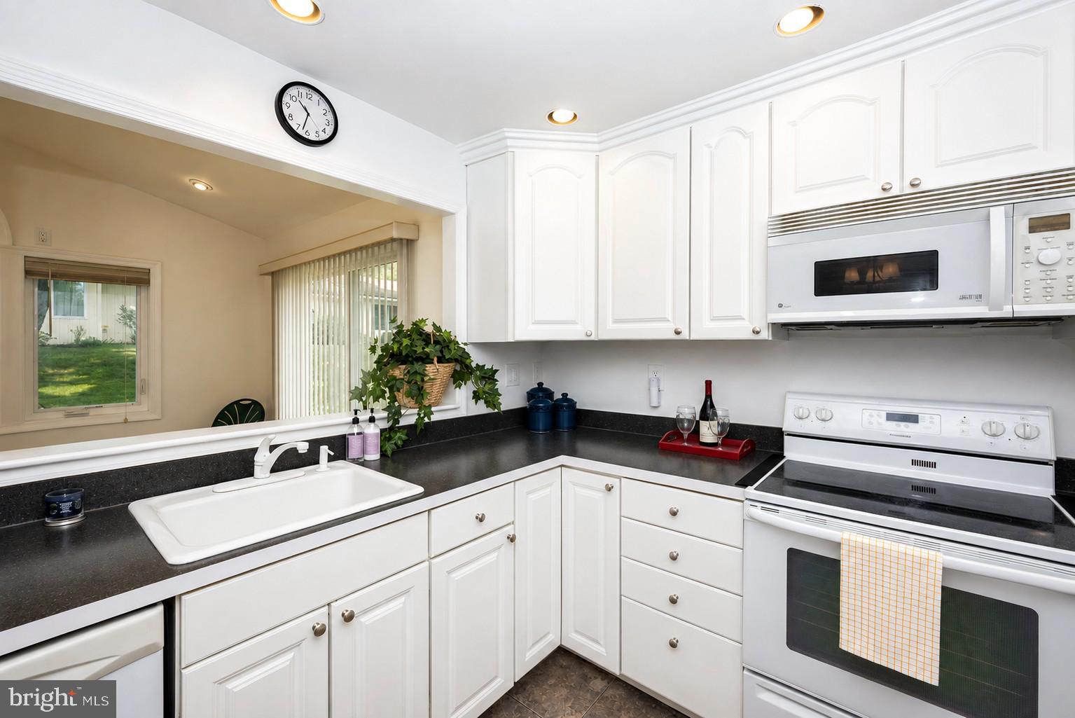 Kitchen with View of Sunroom.