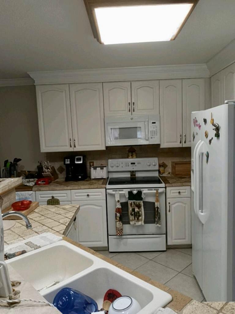 4208 Southeast 27th Street Okeechobee, FL 34974 - Photo 19 of 21 a kitchen with stainless steel appliances granite countertop a refrigerator a stove and white cabinets