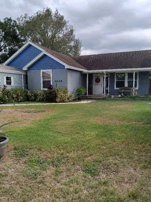 4208 Southeast 27th Street Okeechobee, FL 34974 - Photo 2 of 21 a front view of a house with garden