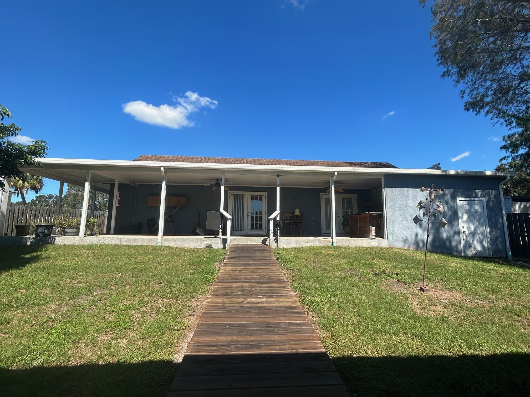 4208 Southeast 27th Street Okeechobee, FL 34974 - Photo 3 of 21 a front view of a house with a yard