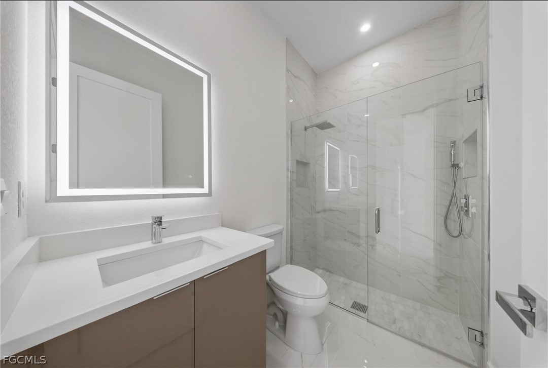 4013 12th Street Southwest Lehigh Acres, FL 33976 - Photo 13 of 29 a bathroom with a sink shower and a toilet
