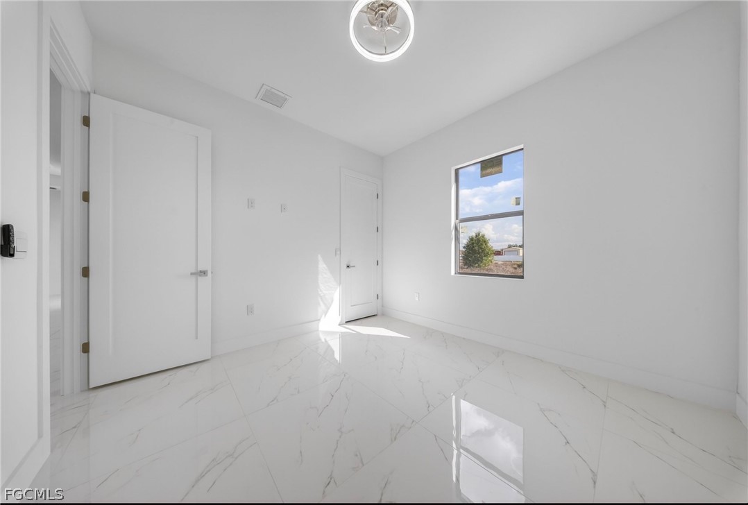 4013 12th Street Southwest Lehigh Acres, FL 33976 - Photo 14 of 29 an empty room with windows