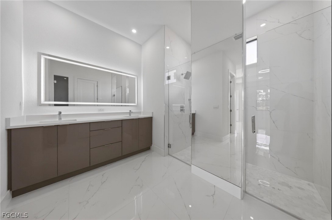 4013 12th Street Southwest Lehigh Acres, FL 33976 - Photo 17 of 29 a bathroom with a double vanity sink mirror and shower