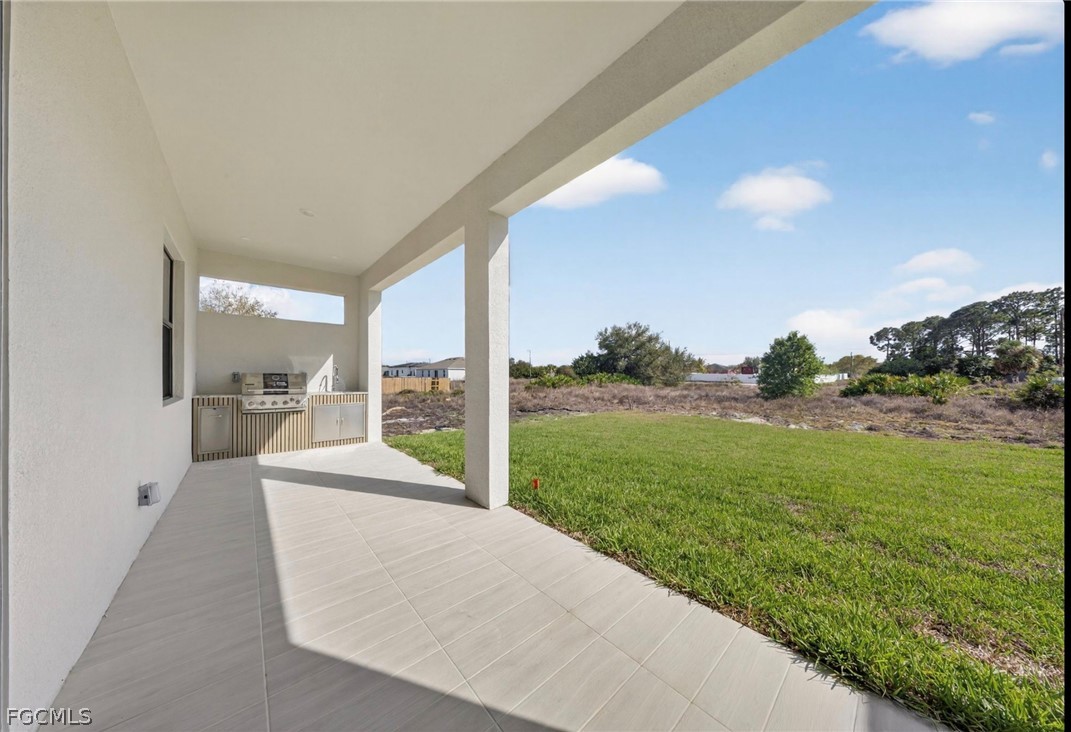 4013 12th Street Southwest Lehigh Acres, FL 33976 - Photo 22 of 29 a view of a patio with a yard