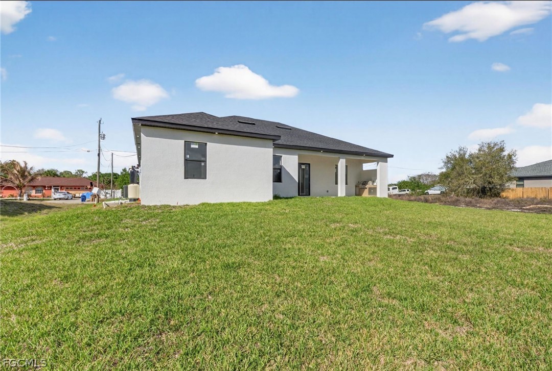 4013 12th Street Southwest Lehigh Acres, FL 33976 - Photo 25 of 29 a view of a house with a yard