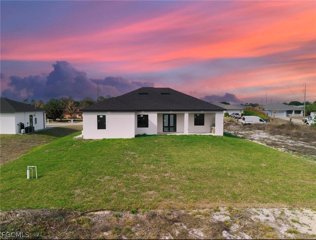 4013 12th Street Southwest Lehigh Acres, FL 33976 - Photo 27 of 29 a front view of a house with a garden and yard