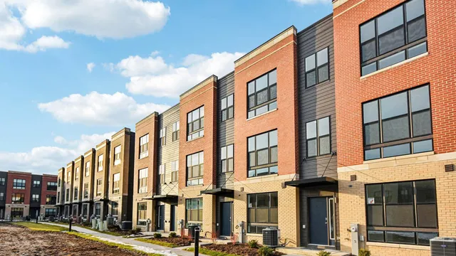 a kitchen with stainless steel appliances granite countertop a stove top oven a sink and a granite counter tops with white cabinets