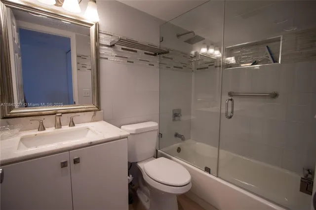 a bathroom with a sink toilet tub and shower