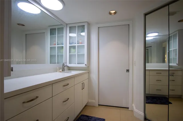 a bathroom with a granite countertop sink mirror and