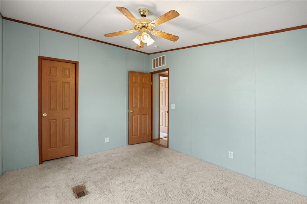 2903 Centaurus Way Granbury, TX 76048 - Photo 16 of 31 Unfurnished bedroom with ornamental molding, a ceiling fan, and carpet flooring