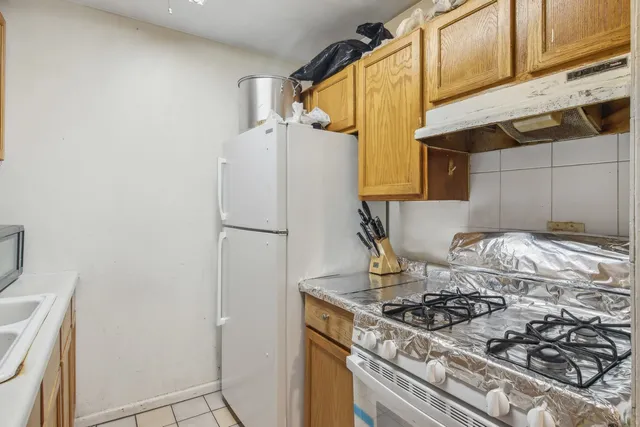 a kitchen with a stove and a refrigerator