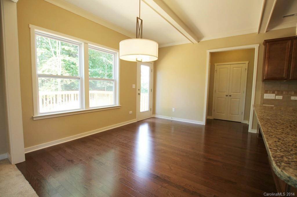 7140 Meyer Road, Unit 309 Fort Mill, SC 29715 - Photo 8 of 16 a view of an empty room with wooden floor and a window