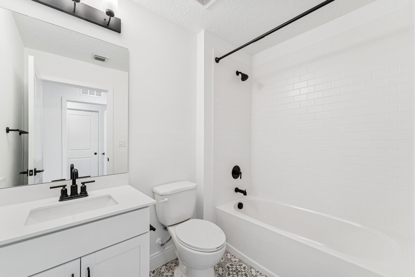 165 Southeast Birch Terrace, Unit 842 Stuart, FL 34997 - Photo 17 of 28 a bathroom with a sink a toilet and a mirror