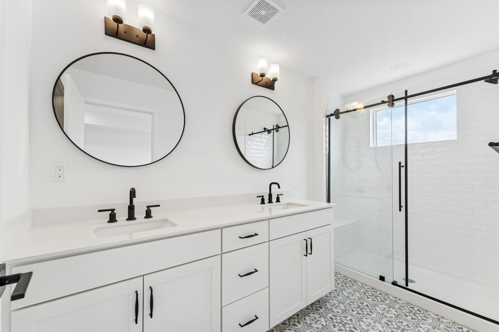 165 Southeast Birch Terrace, Unit 842 Stuart, FL 34997 - Photo 24 of 28 a bathroom with a double vanity sink and a mirror