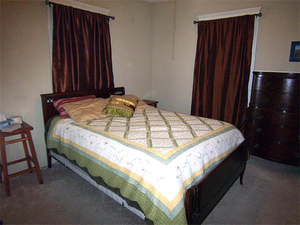 76 Sterling Street Springfield, MA 01107 - Photo 11 of 15 a bed sitting in a bedroom next to a wooden cabinet