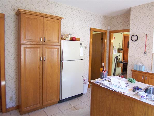 76 Sterling Street Springfield, MA 01107 - Photo 4 of 15 a bathroom with a refrigerator a sink and a mirror