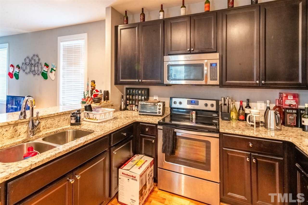914 Chaney Road Raleigh, NC 27606 - Photo 6 of 15 a kitchen with granite countertop stainless steel appliances and sink