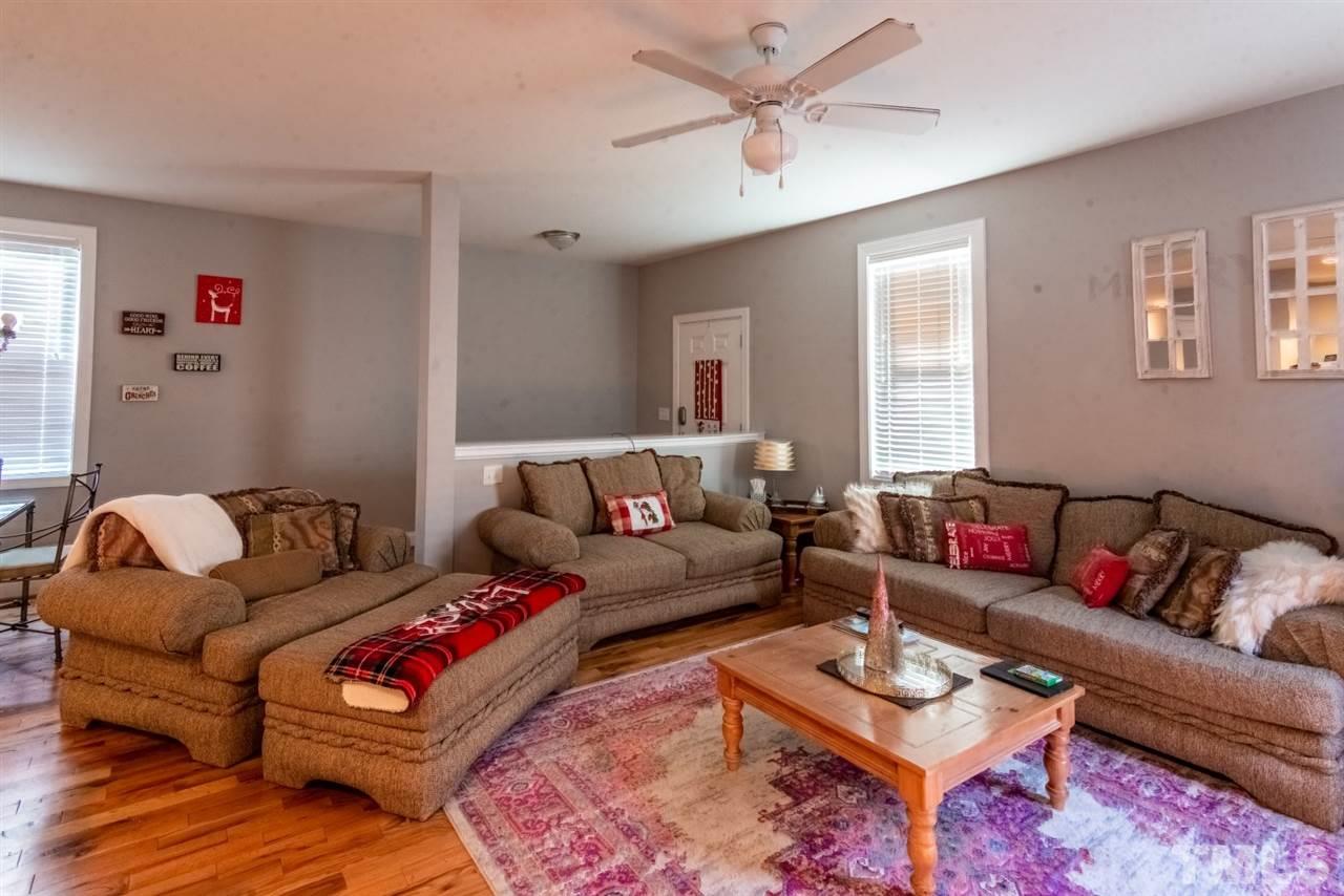 914 Chaney Road Raleigh, NC 27606 - Photo 7 of 15 a living room with furniture a rug and a window