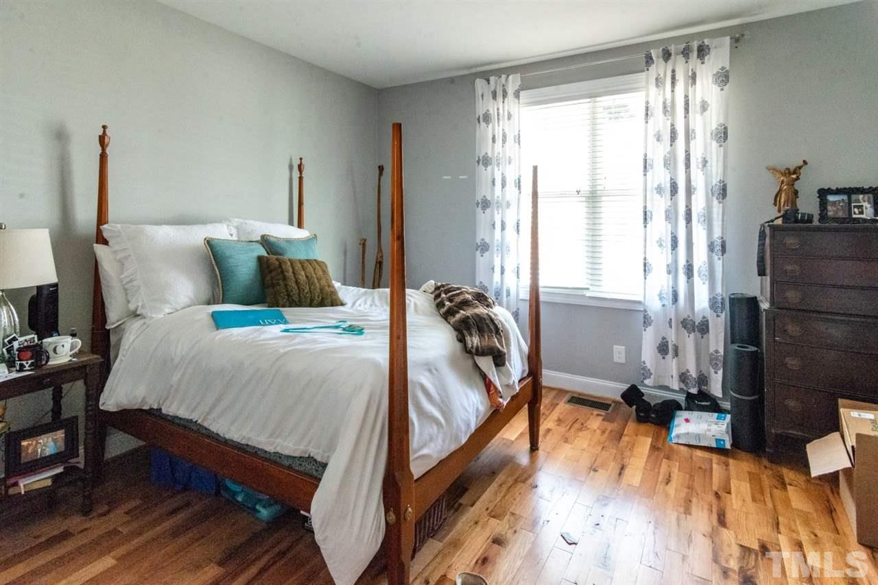 914 Chaney Road Raleigh, NC 27606 - Photo 9 of 15 a bedroom with a bed and wooden floor