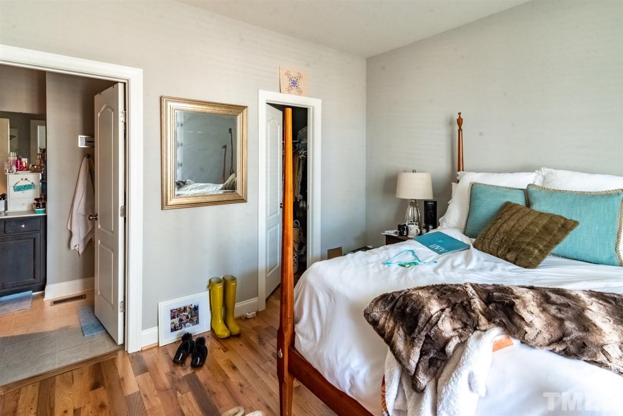 914 Chaney Road Raleigh, NC 27606 - Photo 10 of 15 a bedroom with a bed and a table in it