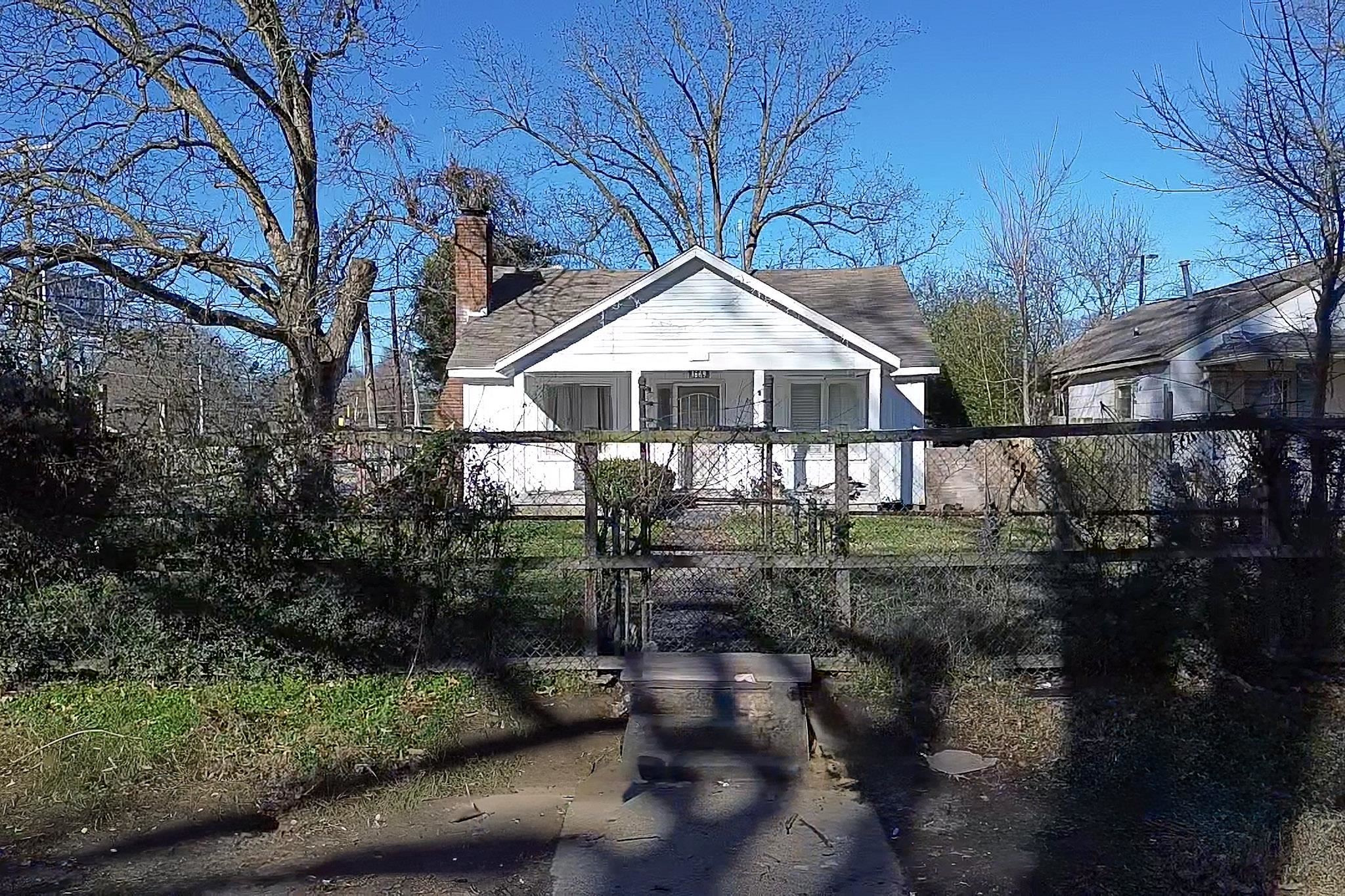 Bungalow-style home with a chimney and covered porch