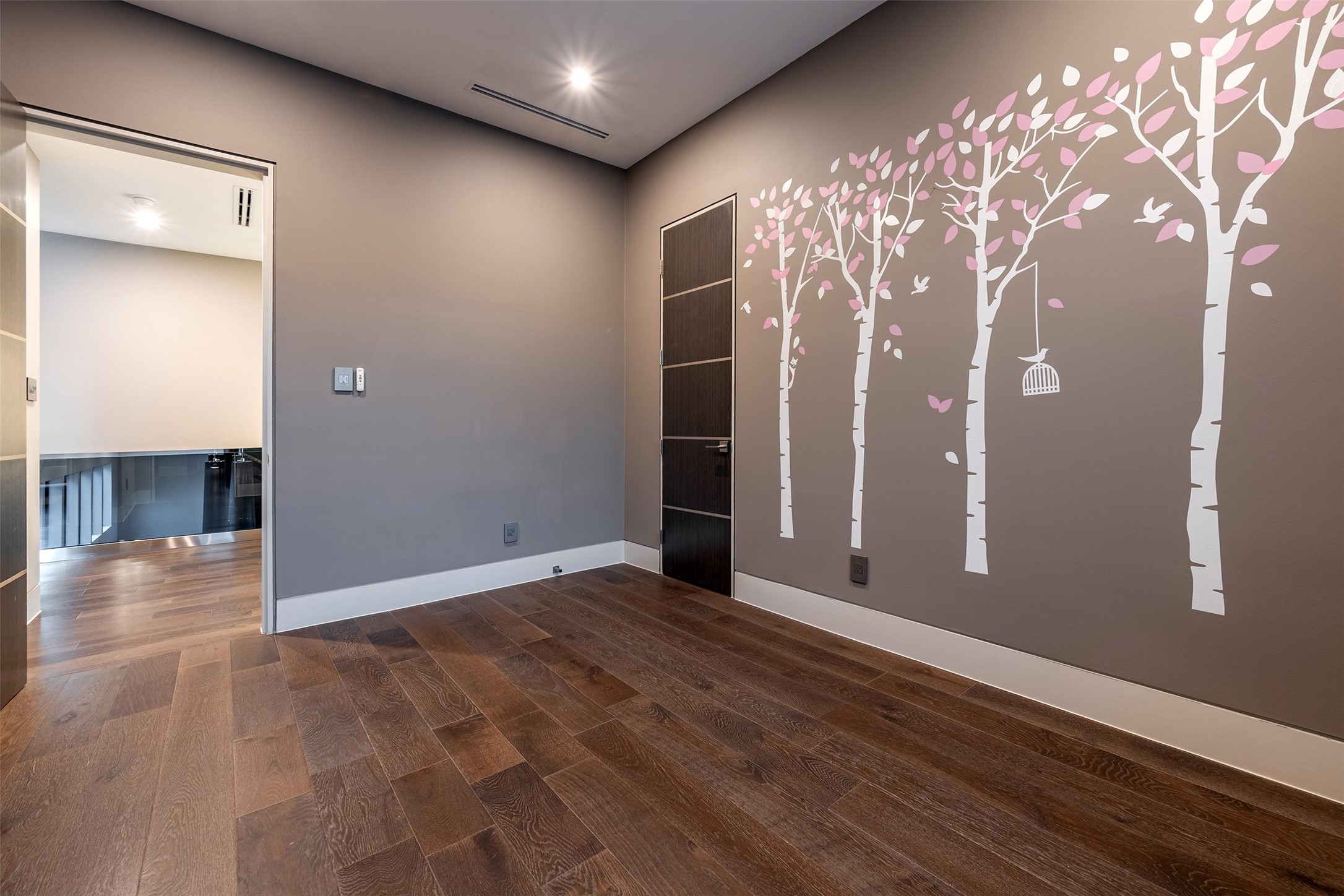 2302 Suffolk Drive Houston, TX 77027 - Photo 28 of 42 an empty room with wooden floor and windows