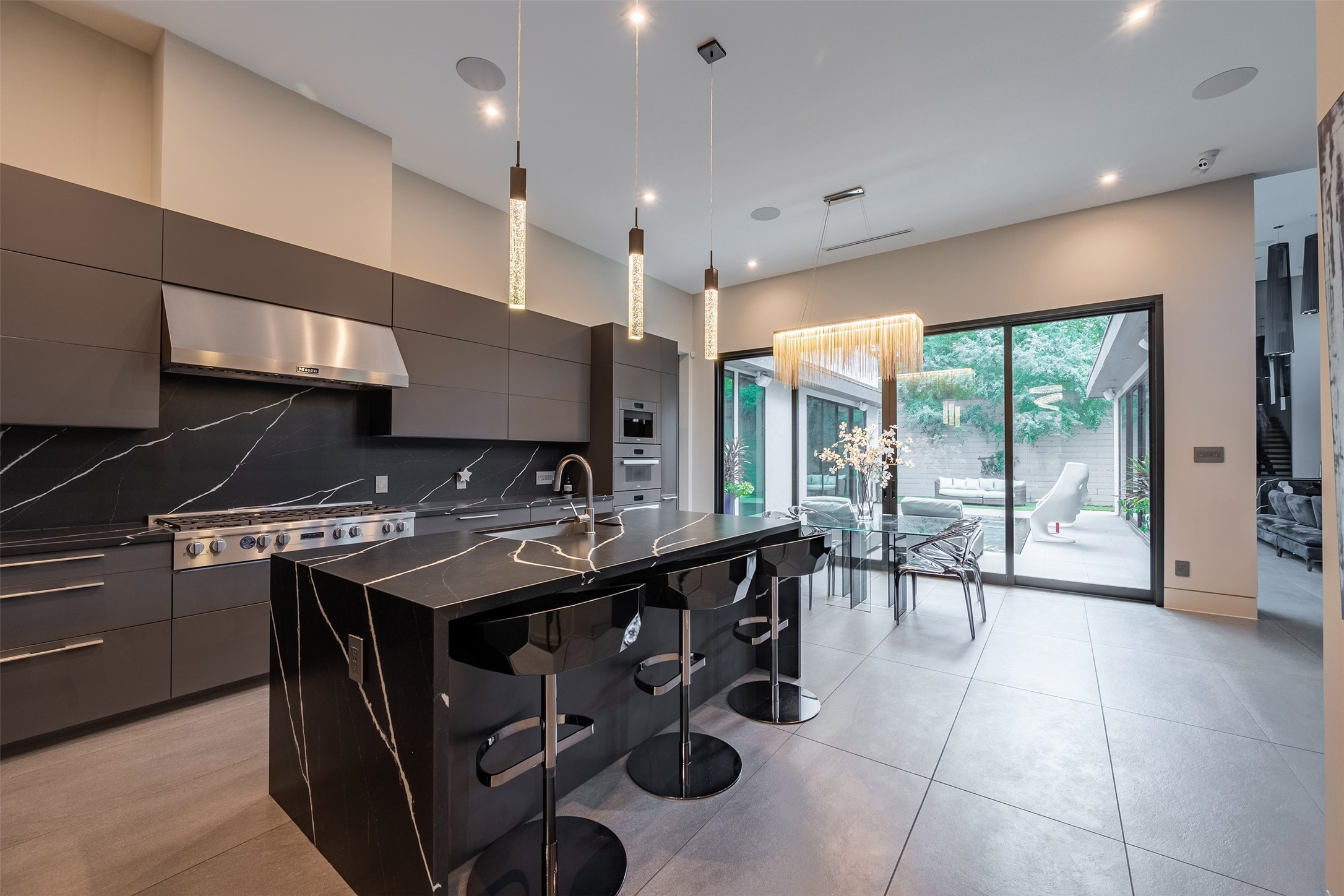 2302 Suffolk Drive Houston, TX 77027 - Photo 8 of 42 a kitchen with stainless steel appliances granite countertop a stove a sink and a microwave