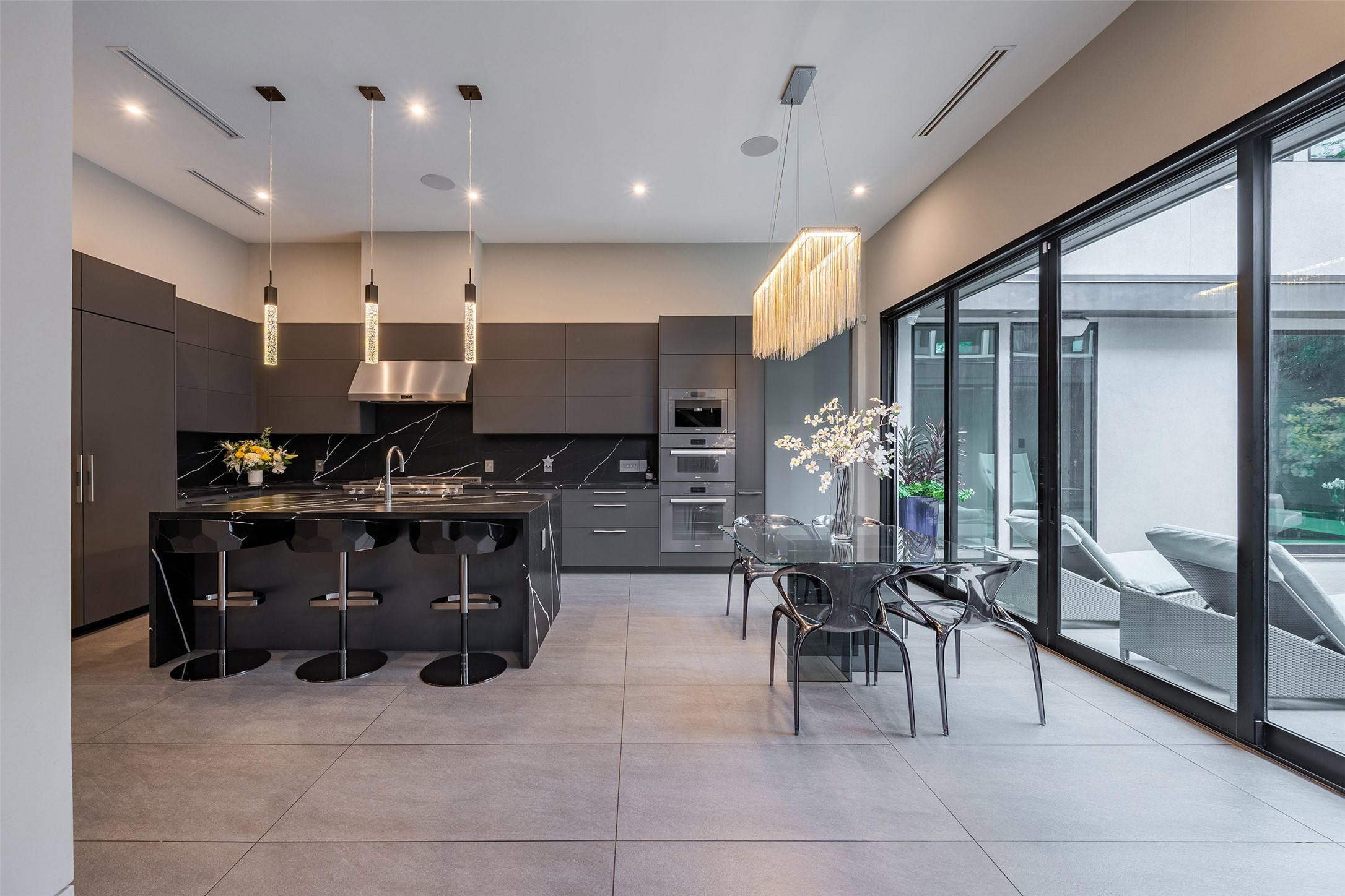2302 Suffolk Drive Houston, TX 77027 - Photo 9 of 42 a kitchen with stainless steel appliances kitchen island granite countertop a stove a sink and a refrigerator