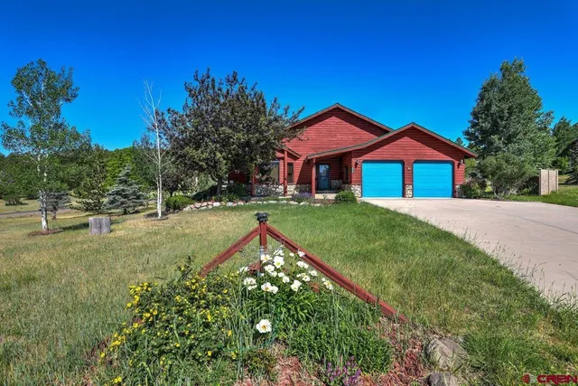 a house with green field in front of it