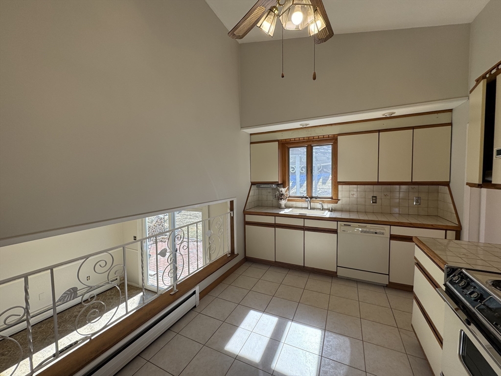 6 Redman Road Canton, MA 02021 - Photo 5 of 16 a large white kitchen with a stove a sink dishwasher and microwave oven
