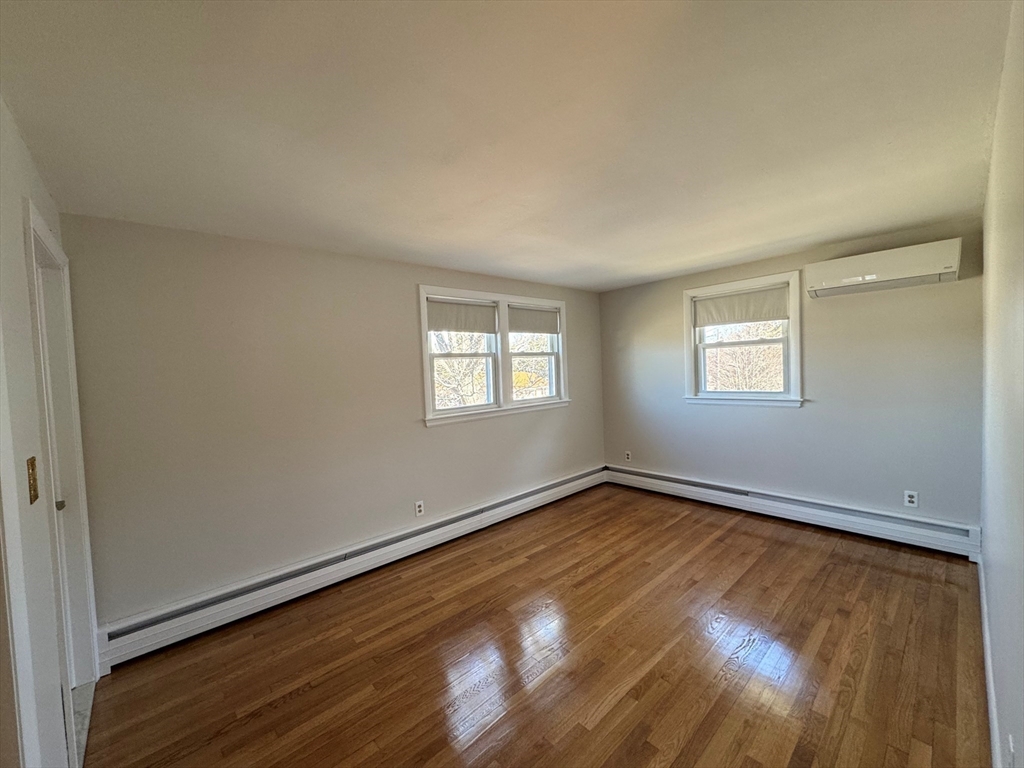 6 Redman Road Canton, MA 02021 - Photo 6 of 16 an empty room with wooden floor and windows