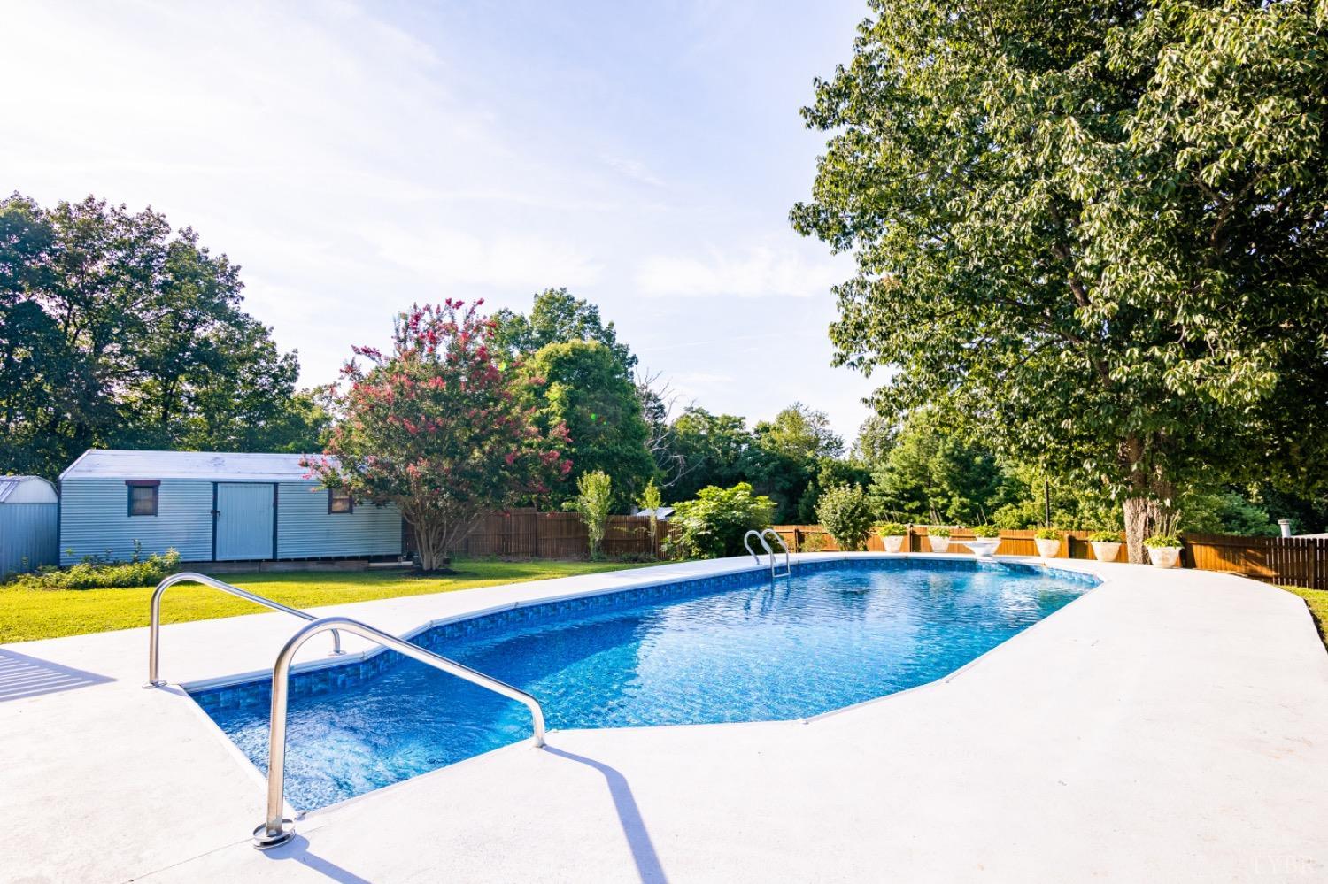 1097 Hummingbird Lane Spout Spring, VA 24593 - Photo 32 of 44 a view of a swimming pool with an outdoor seating and yard