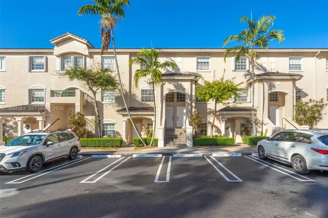 a view of a street with a cars parked in front of it