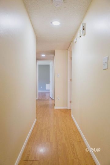 327 Henry Street Ridgecrest, CA 93555 - Photo 13 of 30 a view of hallway with an empty room and wooden floor