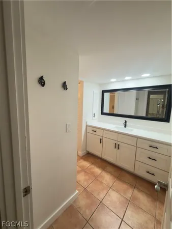 a view of a kitchen with white cabinets