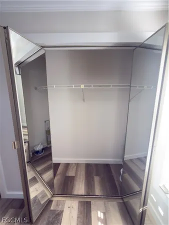 a view of walk in closet with empty racks