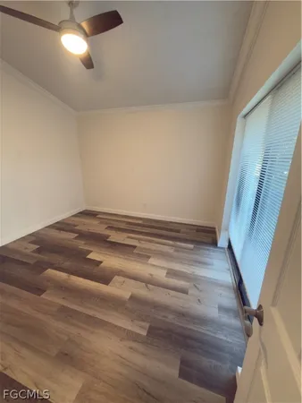 a view of empty room with wooden floor
