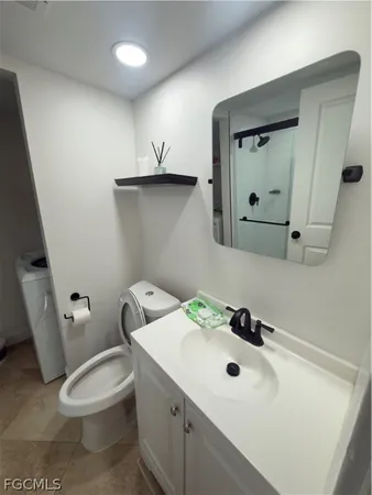 a bathroom with a sink toilet and mirror